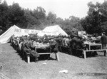 [Refugees eating at outdoor tables. Relief camp in Golden Gate Park?]