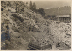 Loading coyote hole on right bank. 1200 lbs of black powder was used. This shot was not successful as no material was moved, July 27, 1913