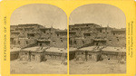 Indian Pueblo of Zuni, New Mexico; view from the interior. The "Pueblo" or town, encloses a quadrangular area within which are the ruins of a church built under the direction of the Jesuit missionaries. The houses are built one above the other to the height of five or six stories. The entrances are mostly from the top, the ascent and descent being made by ladders, no. 16