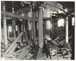 [Two men in earthquake-damaged building]