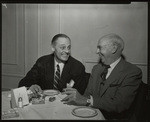 [Two men seated at dining table]