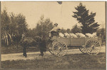 [Charles Brett posed on a milk wagon]