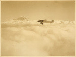 [Biplane above clouds]