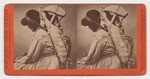 [Side view, American Indian woman carrying infant in cradleboard on back]