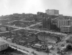 [View looking northwest toward Nob Hill from above circa Stockton and Geary Sts. during reconstruction. Union Square, lower left; Temple Emanu-el, right center; Fairmont Hotel atop hill]