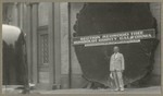 [Man standing in front of large slice of redwood tree from Humboldt County]