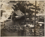 View of toe wall from right hand bank. The high water is flowing about 1 ft. deep over the completed toe wall. March 1, 1914