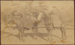 [Two unidentified women pose on two horses]