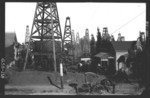 [Oil wells, houses, residents and horse-drawn carriage]