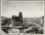 [Erection of Humboldt Building during reconstruction. Intersection of Market, O'Farrell and Grant Sts., right; City Hall in distance, left]