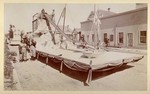 [Parade float of lumber schooner model]