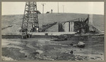 [Mud in foreground with man, little girl, and oil well in background]