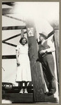 [Alfred Fuhrman and woman standing at base of oil well]