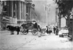 [Refugees loading wagon during fire. Larkin St.? City Hall in distance, left]