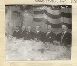 [Prominent citizens at a banquet]