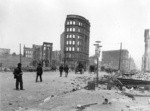 [View of ruins and rubble along Market St. Looking north from near Seventh St. Flood Building in distance, right]