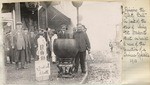 Ringing the Liberty Bell in front of the store of Sing Fat.