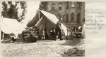 Chinese family camped in a vacant lot.