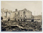 [Two men standing in rubble of Los Angeles Times building]