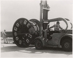 [Exterior detail view of forklift with electrical cable, Newberry Electric Corporation, on bridge]