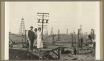 [Alfred Fuhrman and women with oil wells behind them]