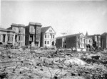 [Houses along Howard St. viewed from across ruined lots]