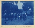 On horseback in front of schoolhouse