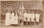 [Florine Wenzel and schoolchildren posed with flag]