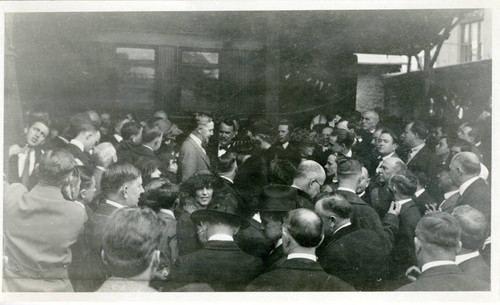 Group of men and women standing and talking