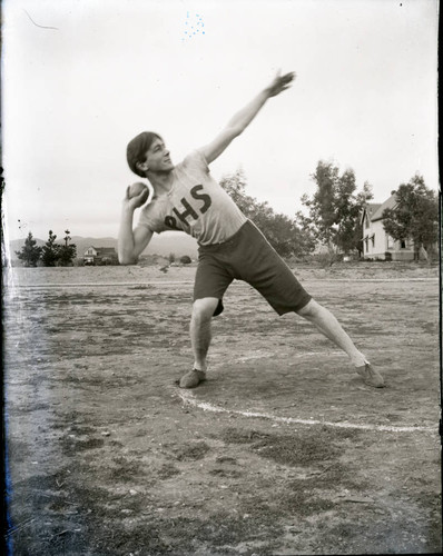 Track and field athlete shot putting