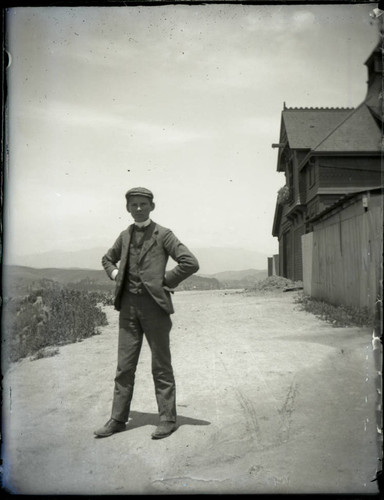 Young man beside building