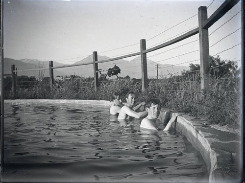 Swimming pool with three boys