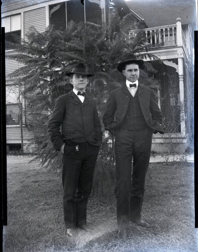 Unidentified men in front of house