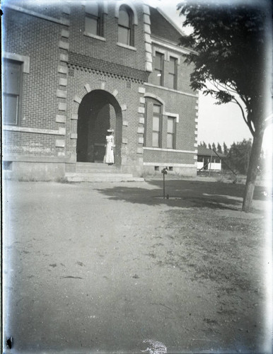 Florence Howard in front of brick building