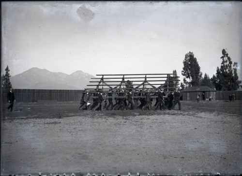 Students move bleachers for game between USC and Pomona College