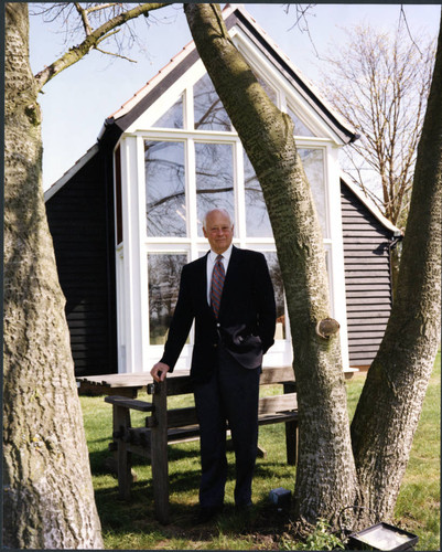 Charles Handy, color photo outside near table