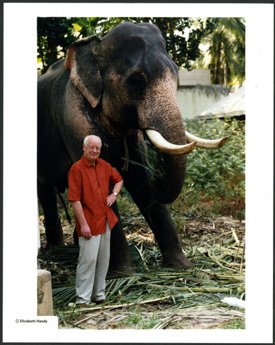 Charles Handy, color photo outside adjacent to an elephant