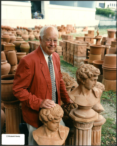 Charles Handy, color photo outside near sculpture