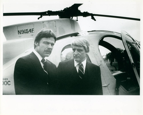 Two individuals standing near a helicopter for off-campus study, Claremont McKenna College