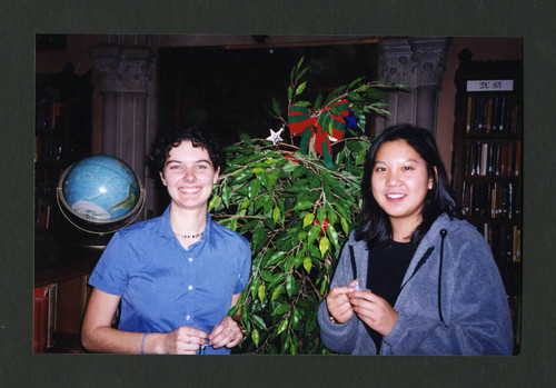 Scripps students standing by a festively decorated tree, Scripps College