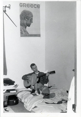 Student Playing a Guitar