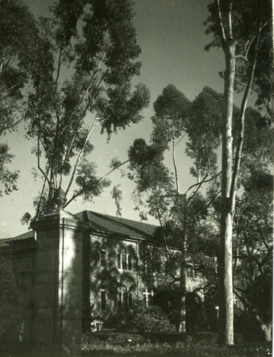 Holmes Hall obscured by trees, Pomona College
