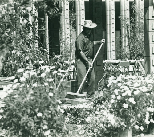 Sprague Library with gardener, Harvey Mudd College