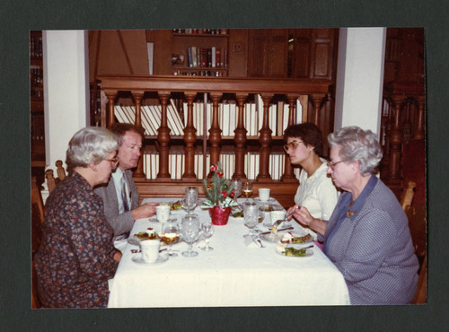 Four people eating dinner together at a table, Scripps College