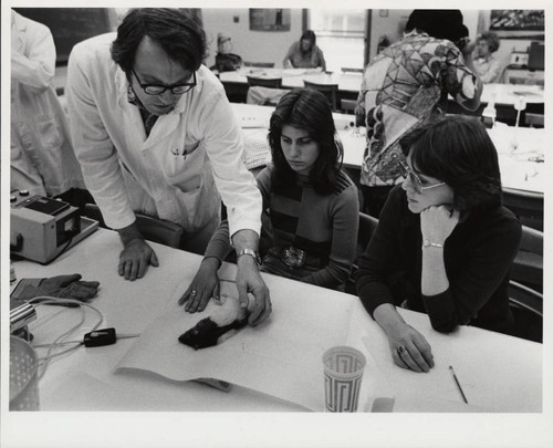 Biology students and professor with rat, Scripps College