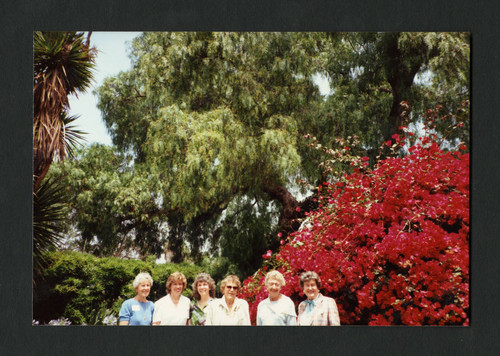 Macpherson Society members stand side by side and smile, Scripps College