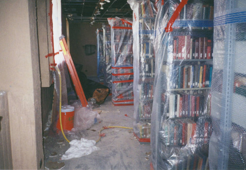 Books wrapped in plastic during renovation of Honnold/Mudd Library