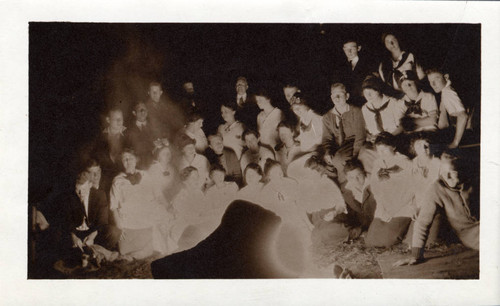 Pomona College students around a campfire