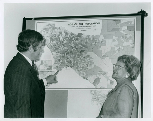 Two individuals standing in front of census maps, Claremont McKenna College