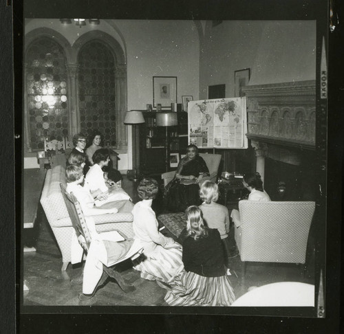 Miss Ivinne speaks with a group of Scripps students in Denison Library, Scripps College